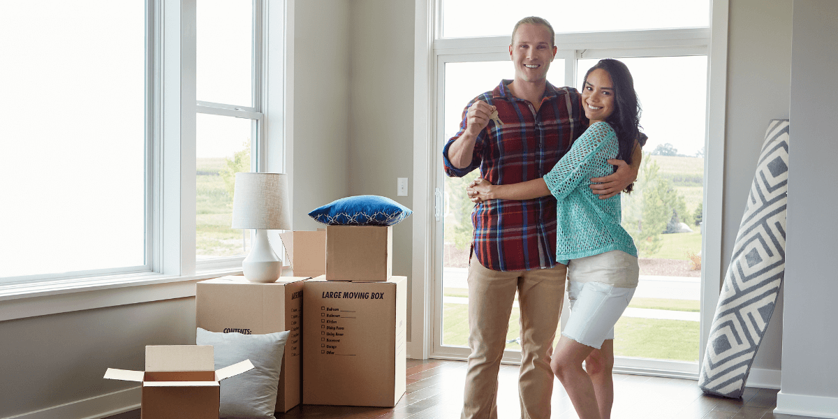 Two people hugging in their new home
