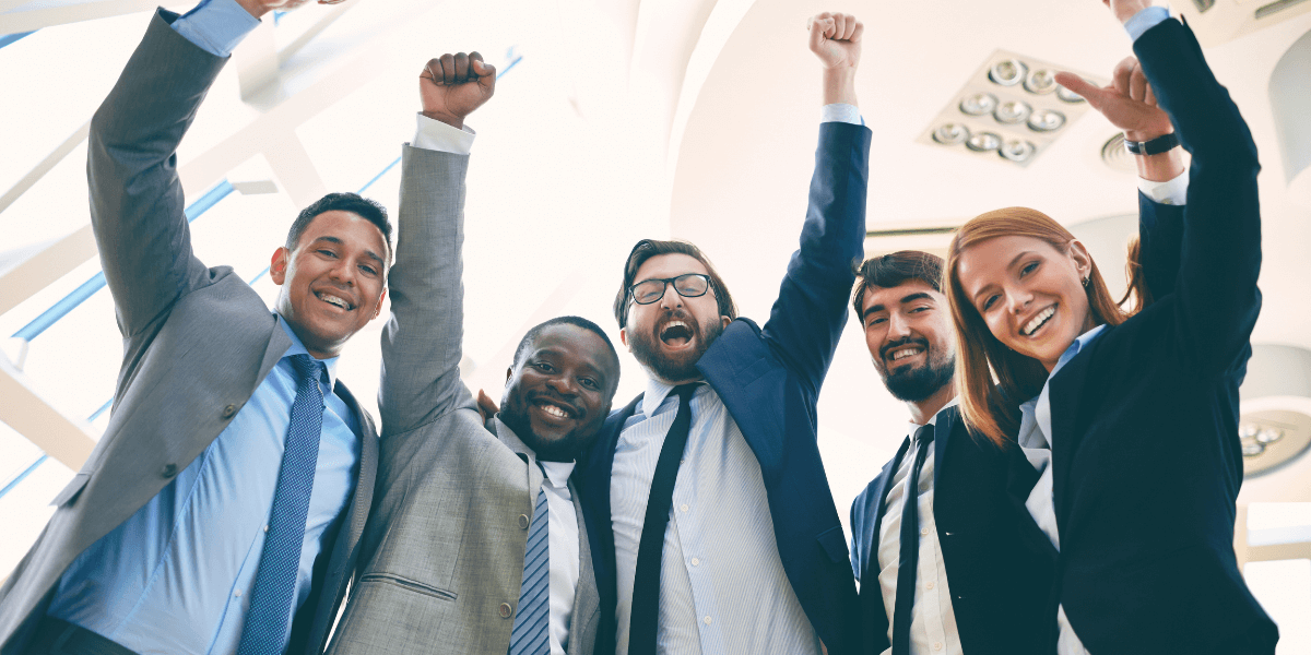 Employees raising their arms | Employee Benefits